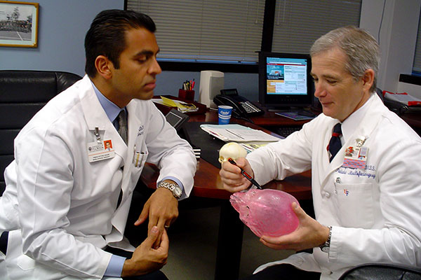 University of Florida oral and maxillofacial surgeons Dr. Fattahi and Dr. Steinberg discuss a surgical case with a skull model